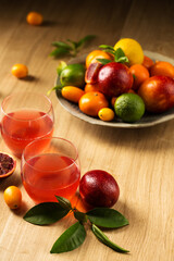 two glasses with a delicious citrus drink on a wooden table