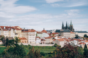 Naklejka na ściany i meble Prague, Czech Republic, a fairy tale with orange-roofed houses and Prague Castle in harmony with nature