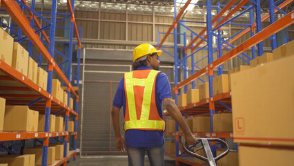 Portrait of Indian worker working in large warehouse retail store industry. Rack of stock storage. Interior of cargo in ecommerce and logistic concept. Depot. People lifestyle. Shipment service.