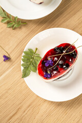 Pannacotta with berry jelly and violet, top view
