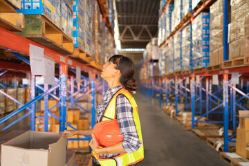 Portrait of worker woman working in large warehouse retail store industry. Rack of stock storage. Interior of cargo in ecommerce and logistic concept. Depot. People lifestyle. Shipment service.