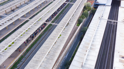 Aerial view of Roma Ostiense, a railway station in Rome, Italy. Some people are waiting for a train.