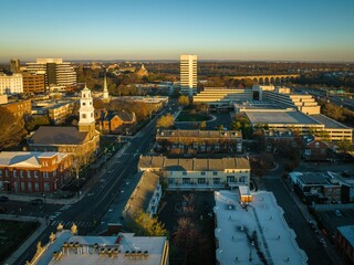 Aerial shot of the urban buildings surrounded by trees at dawn, New Brunswick, USA