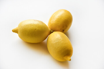 Yellow ripe lemon on a white background. Juicy lemons close-up. Isolate of the fruit of a yellow lemon.