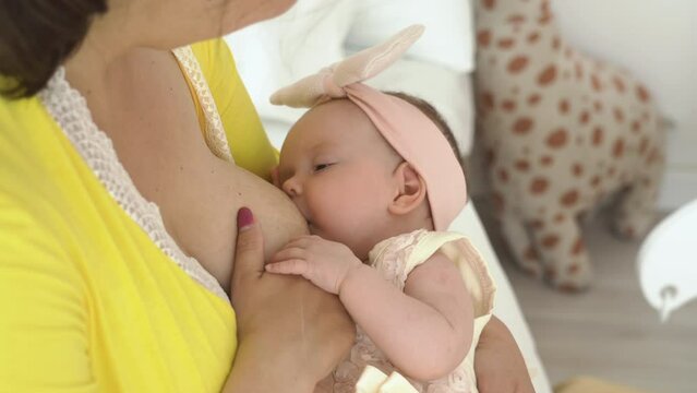 Two months old cute baby drinking breastmilk. Mothers day concept