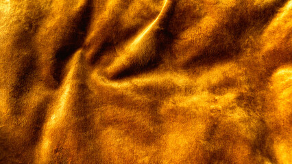Close-up of fabric texture. Gold color background Yellow abstract patterns on the fabric surface....