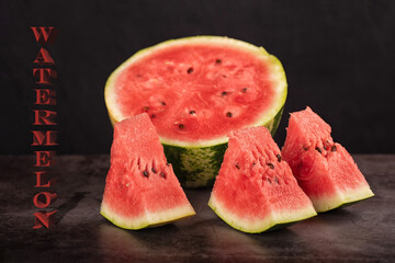 Top view of watermelon slices and halved watermelon on kitchen counter