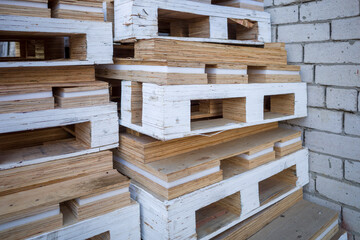 Stack of wooden pallets for industrial and transport applications near warehouses