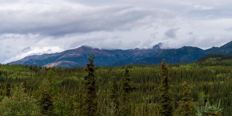 Scenic shot of the Alaska Range in the Southcentral region of Alaska, USA under a cloudy sky