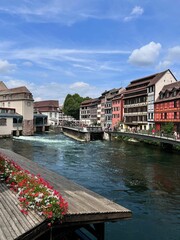 Vertical view of a beautiful river flowing in the Strasbourg city with beautiful buildings