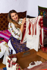 Romanian woman opening the costume chest
