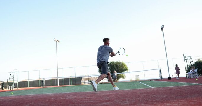 A man and a woman play an tennis court, slowmotion