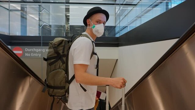Male Passenger Going Down On An Escalator In A Dubai Airport