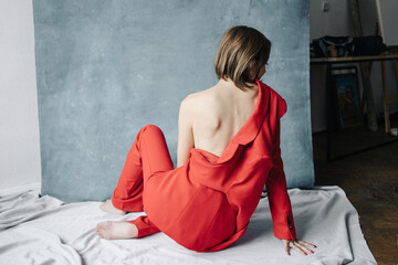 Open back woman in red suit