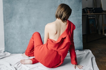 Open back woman in red suit