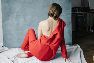 Open back woman in red suit