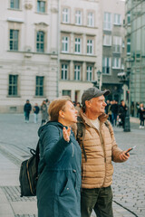 60s years old senior tourists looking for a way by using mobile phone, Wroclaw, Poland