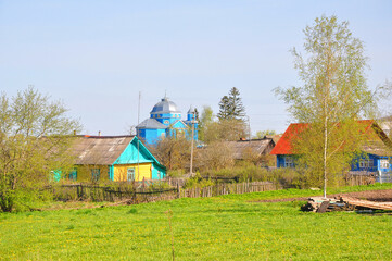 Houses of local residents and the Church of the Transfiguration of the Savior in the agricultural town of Smolyany. Belarus
