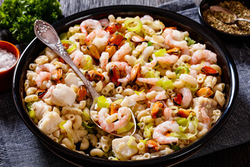 macaroni salad with shrimps, mussels, fish, leek