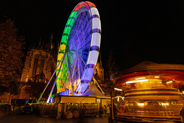 christmas market on the cathedral square in Erfurt with ferris wheel and carousel in front of the old cathedral