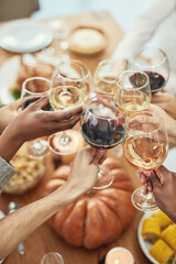 Closeup, hands and wine for celebration, group and dining table for lunch together. Top view, toast...