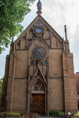 Vertical shot of the Loretto Chapel in Santa Fe, New Mexico with elegant gothic arches and windows