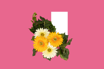 White and yellow flowers on a pink background next to white, blank paper. Space for text.