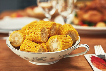 Corn, celebration and dinner on a table for Christmas, lunch and nutrition on holiday. Feast, Thanksgiving and food on a dining table for healthy eating, sharing and celebrate festive with a meal