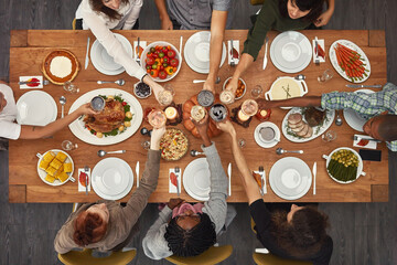 Food, top view and friends toast at a table in celebration of thanksgiving at a party or social...