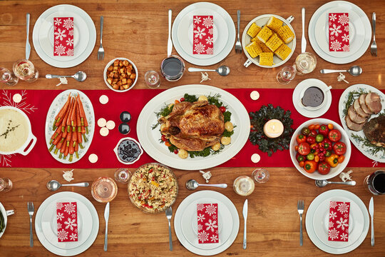 Christmas, Party And Food With A Festive Feast On A Dinner Table In A Home From Above For Celebration. Chicken, Event And Nutrition With A Meal Setting On A Wooden Surface In The Holiday Season