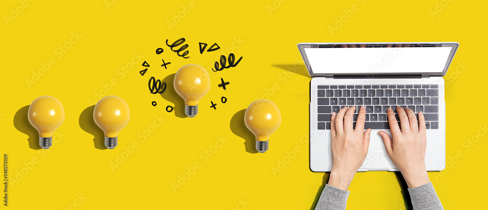 Poster idea light bulbs with person using a laptop computer from above