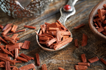 Pieces of red sandalwood on a wooden spoon, close up