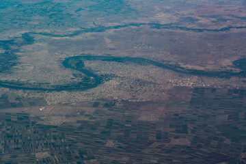aerial landscape view of winding course of the "Blue Nile" river around the City of Wad Madani (capital of  State Gezira) on the West Bank of river Blue Nile in east-central Sudan - Africa