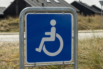 Blue colored sign for disabled car parking. 