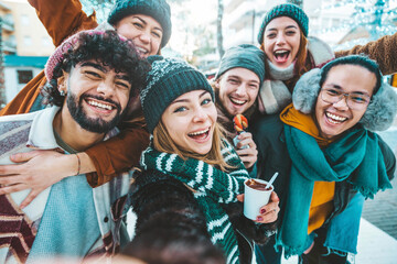 Fototapeta Multicultural friends wearing winter clothes enjoying winter vacation together - Happy young people celebrating new year eve - Friendship and winter holidays concept obraz