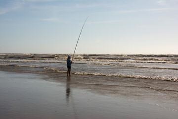 Old lady fishing on the seafront