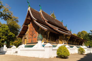 Buddhist building of traditional Lao architecture at Wat Xieng Thong temple in Luang Prabang, Laos