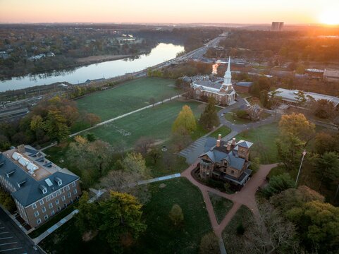 Fototapeta Drone view of a city skyline with buildings near the river in New Brunswick, Rutgers, Hub City, USA