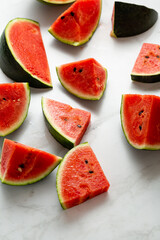 Pieces of red watermelon food summer top view on light surface