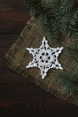 crochet white snowflake on linen backgraund