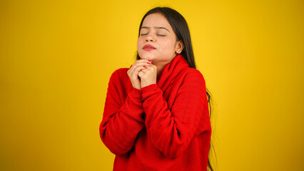 Young Woman feeling cold isolated over yellow background, Shivering due to cold, beautiful Asian...