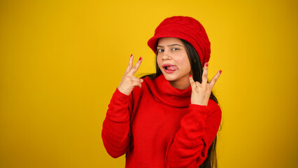 Young woman wearing winter clothes isolated over colour background, Beautiful girl wearing sweater