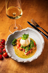 Burrata italian cheese snack with tomatoes served on white plate