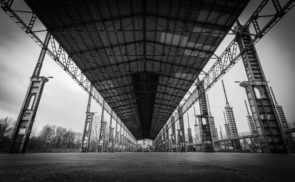 Grayscale shot of the industrial ruins of a factory at Parco Dora park in Turin, Italy