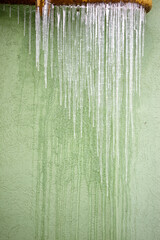 Ice on a light green wall background