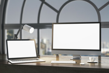 Close up of night designer desktop with empty white laptop computer screens, coffee cup and keyboard on wooden desktop and window with city view background. Mock up, 3D Rendering.