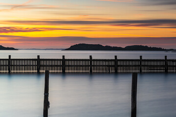 Naklejka premium Poles standing in water at empty harbour