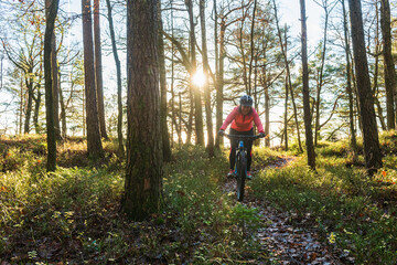 Woman riding a bike in the woods