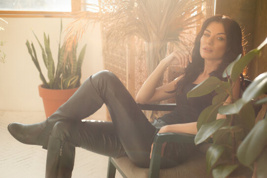 Fashionable  Woman In Black Clothes Sitting 