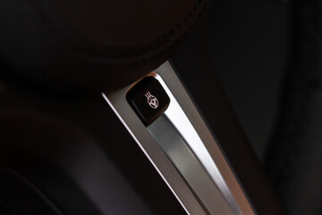 Close up of car steering wheel heating control. Steering wheel heating button in the car.